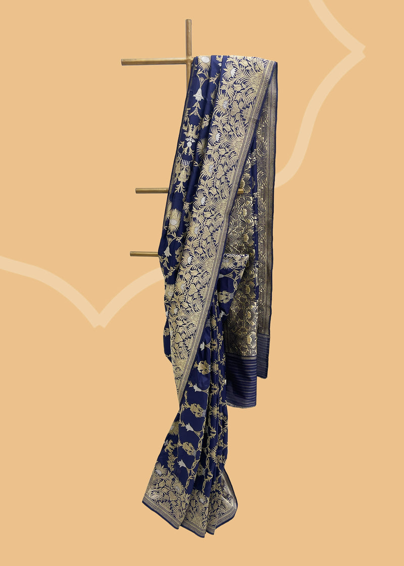 A navy blue oriental inspired woven saree in gold silver ektaara weave.. Shop the best collection of authentic, handwoven, pure benarasi sarees with Roliana New Delhi