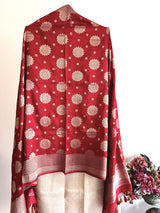 A red silk dupatta wuth floral motifs scattered all over the pure banarasi silk dupatta by Roliana Weaves