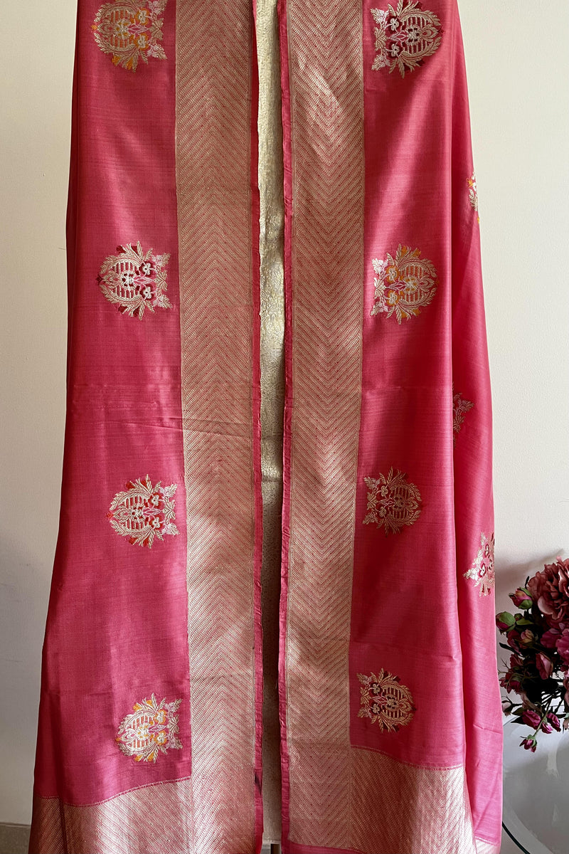 A coral colored silk dupatta with oriental motifs in sona roopa zari and delicate meenakari work all over by Roliana Weaves.