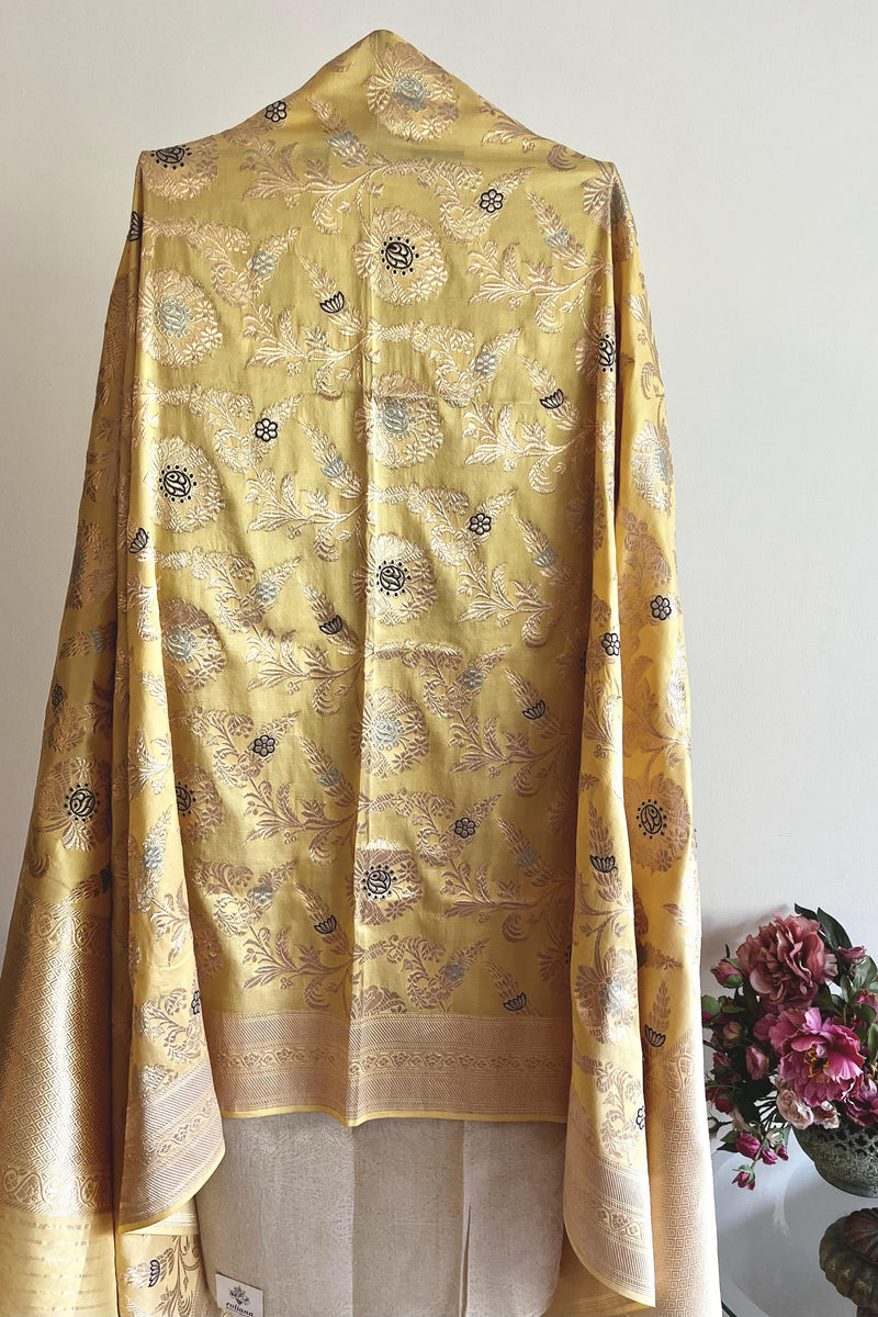 Lemon yellow silk dupatta with jaal woven with multicoloured meenakari work and a traditional benarasi barfi border by Roliana Weaves.