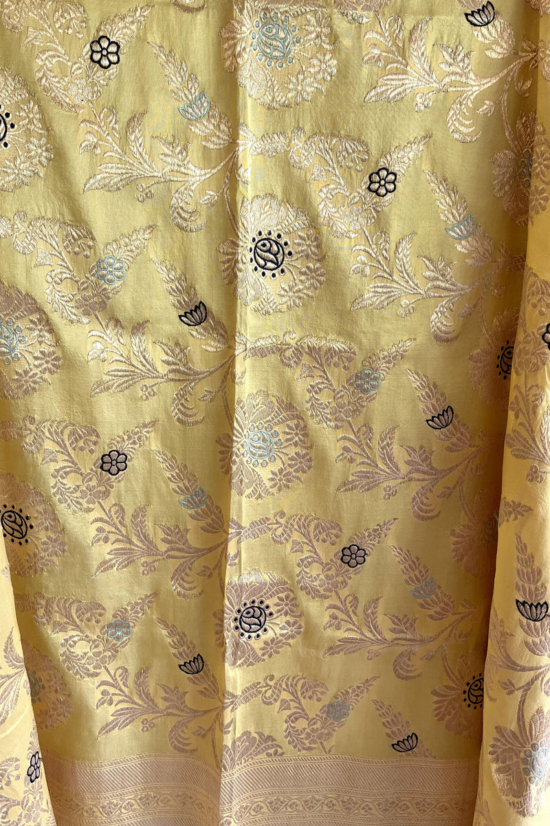 Lemon yellow silk dupatta with jaal woven with multicoloured meenakari work and a traditional benarasi barfi border by Roliana Weaves.