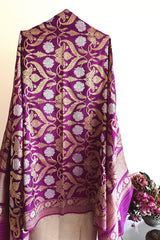 A traditional benarasi silk dupatta in jamuni colour with all over jaal in sona roopa zari and a barfi border by Roliana Weaves.
