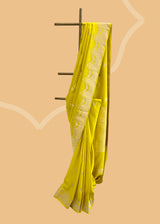 A lime  green  soft silk saree with small zari bootis all over and a beautiful trellis border with scallops and flowers.. A pure Banarasi Sari Shop the best collection of authentic, handwoven, pure benarasi sarees with Roliana New Delhi