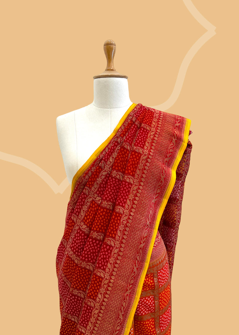 A Red shaded bandhani pure georgette saree in Benares weave suitable for all festive occasions. A pure Banarasi wedding Sari Shop the best collection of authentic, handwoven, pure benarasi sarees with Roliana New Delhi