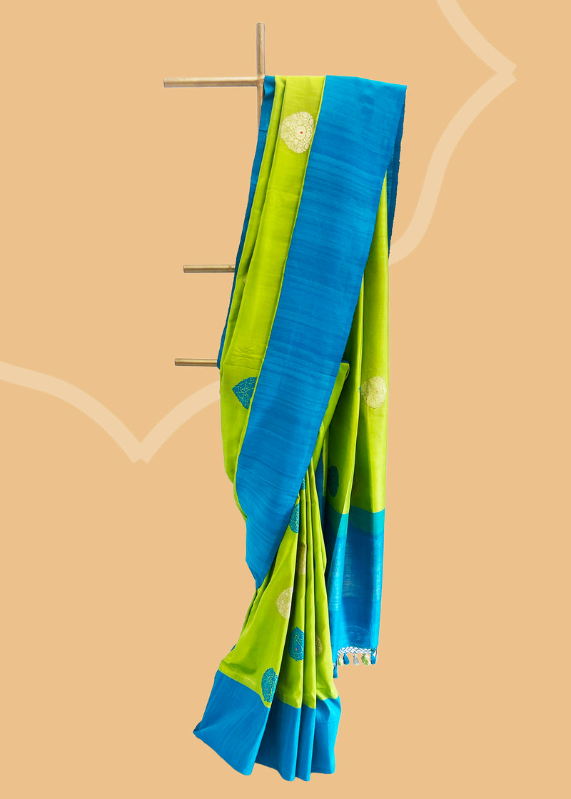 Olive green saree in silk with zari and contrast thread bootis in firozi and complemented by a huge thread border and pallu of firozi colour Shop the best collection of authentic, handwoven, pure benarasi sarees with Roliana New Delhi