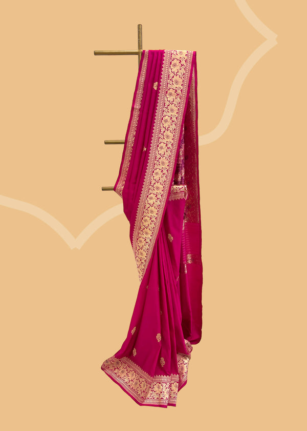 A pink silk saree with woven floral bootas an ornamental floral border and pallu.. A pure Banarasi Sari Shop the best collection of authentic, handwoven, pure benarasi sarees with Roliana New Delhi