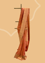 A salmon peach gajji silk saree with meenakari bootis and pallu in ornamental weave. A pure Banarasi Sari Shop the best collection of authentic, handwoven, pure benarasi sarees with Roliana New Delhi