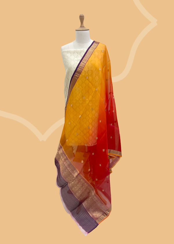 A shaded organza bootidar dupatta in shaded of red and orange with a contrast wine and yellow kanni. Shop the best of Banarasi sarees, dupattas and lehengas at Roliana New Delhi