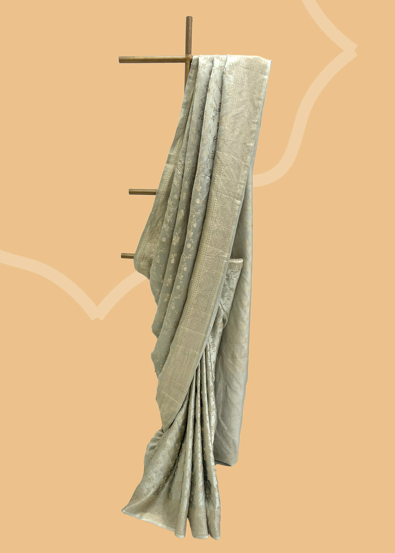  A gajji silk saree in egg shell gray with a delicate gold leaf jaal all over in a dainty weave.
