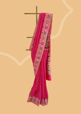 An elegant silk saree in a beautiful Rani pink colour with small bootis all over and a beautiful floral meenakari pallu and border