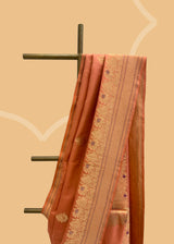 A salmon peach gajji silk saree with meenakari bootis and pallu in ornamental weave. A pure Banarasi Sari Shop the best collection of authentic, handwoven, pure benarasi sarees with Roliana New Delhi
