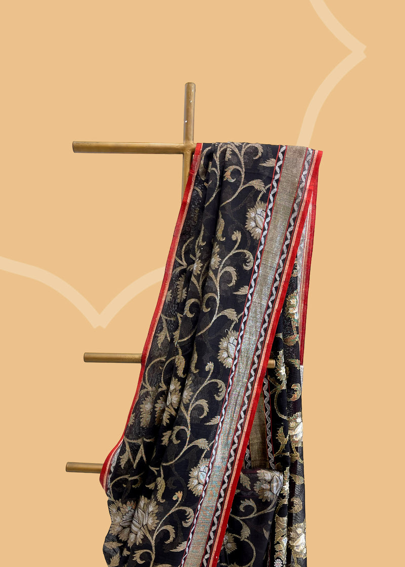 A pure muslin black saree with jamdani jaal woven in sober and gray zari and a contrast red kanni. A pure Banarasi wedding Sari Shop the best collection of authentic, handwoven, pure benarasi sarees with Roliana New Delhi