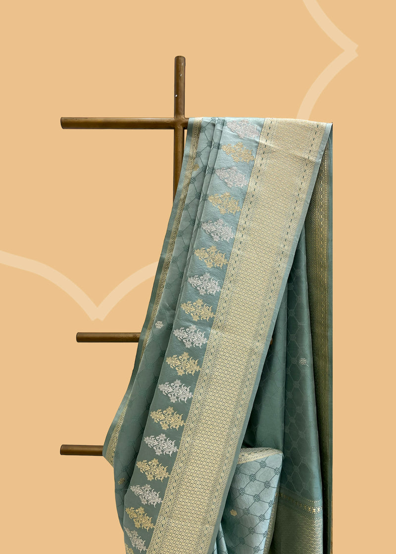 A beautiful powder blue satin tanchoi saree with silver and gold detalling of bootis and border. A pure Banarasi wedding Sari Shop the best collection of authentic, handwoven, pure benarasi sarees with Roliana New Delhi