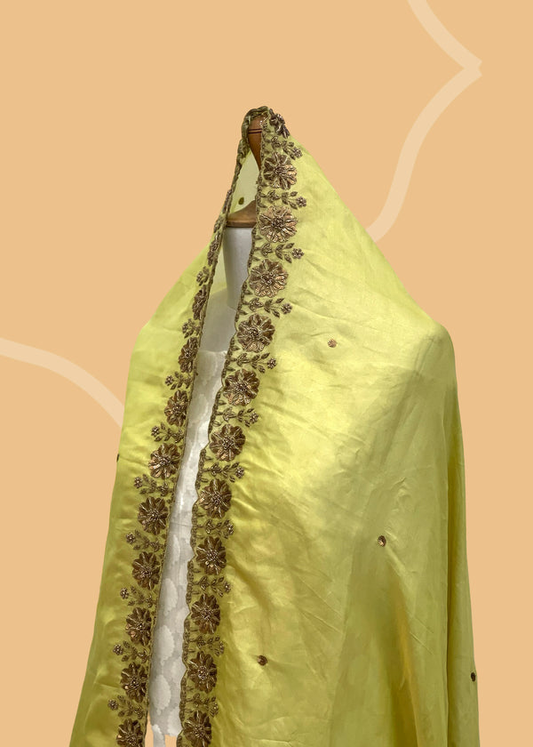 a green tissue dupatta with soft embroidery of flower motifs all around the dupatta. Shop the best of Banarasi sarees, dupattas and lehengas at Roliana New Delhi