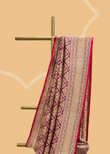 A wine coloured silk brocade saree with barfi weave in zari and a contrast maroon kanni pure Banarasi Sari Shop the best collection of authentic, handwoven, pure benarasi sarees with Roliana New Delhi