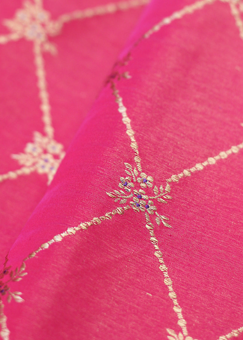 A handloom Rani pink barfi jaal in tanchoi weave with delicate meenakari flowers in satin silk. Shop pure handloom Benarasi Fabric thaans at Roliana Weaves New Delhi
