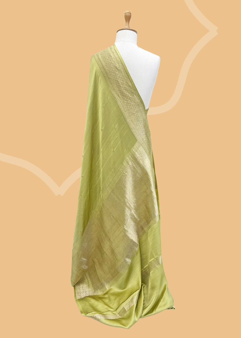 A mint green gajji silk saree with periwinkle  bootis all over and a woven barfi border and pallu. Shop the best collection of authentic, handwoven, pure benarasi sarees with Roliana New Delhi