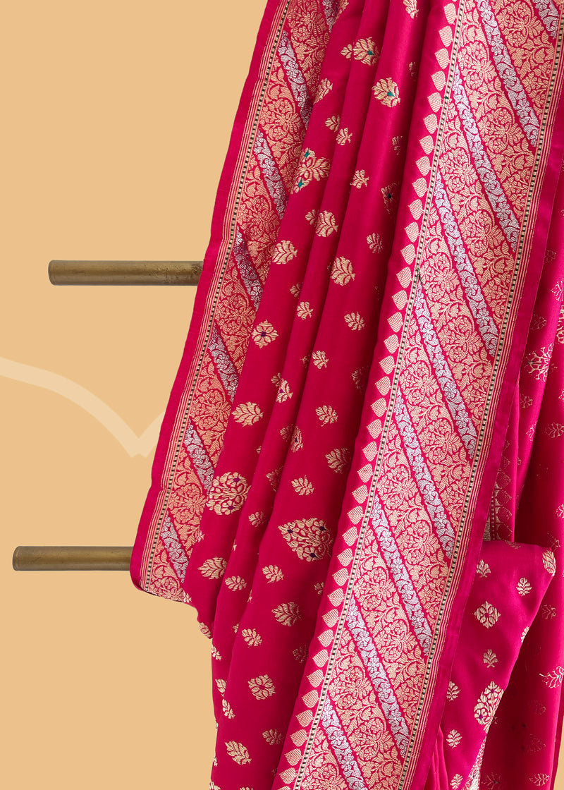 A Rani pink soft silk traditional saree in ektaara silk with kadhwa meenakari bootas and badla border with aarhi stripes Shop the best collection of authentic, handwoven, pure benarasi sarees with Roliana New Delhi