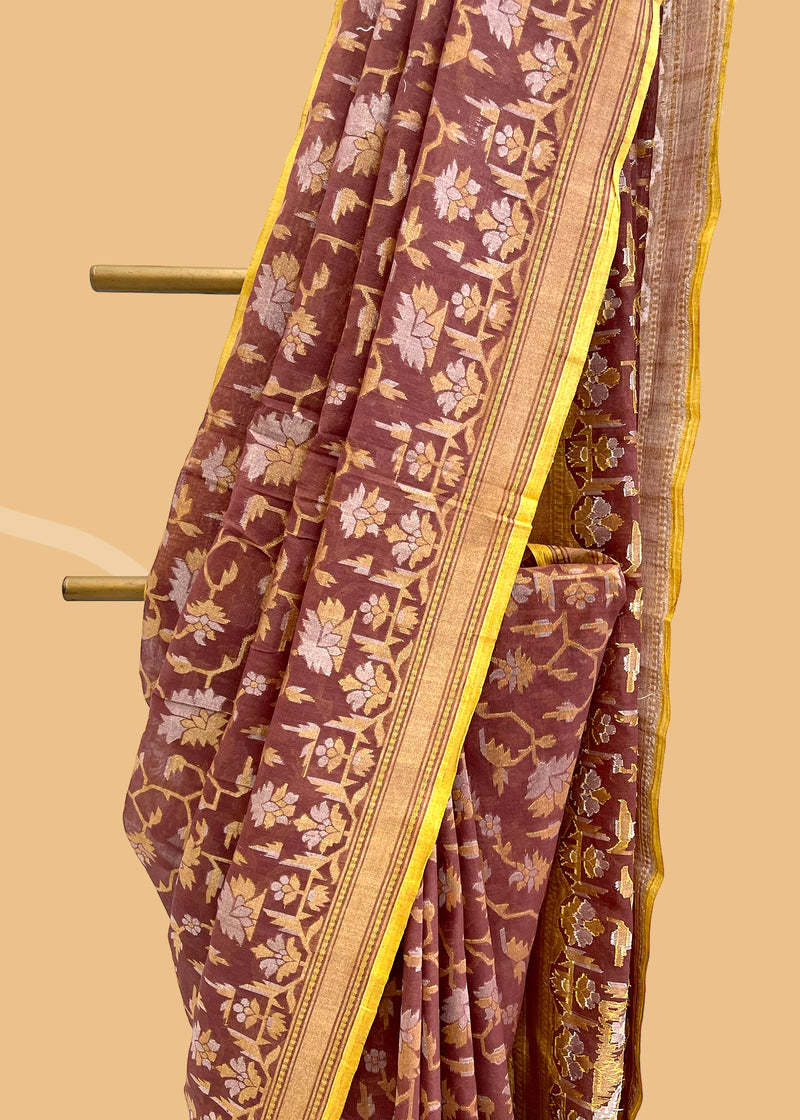 A brick red katha colour jamdani woven muslin saree with gold and silver zari and a contrast lime green kanni. . A pure Banarasi wedding Sari Shop the best collection of authentic, handwoven, pure benarasi sarees with Roliana New Delhi