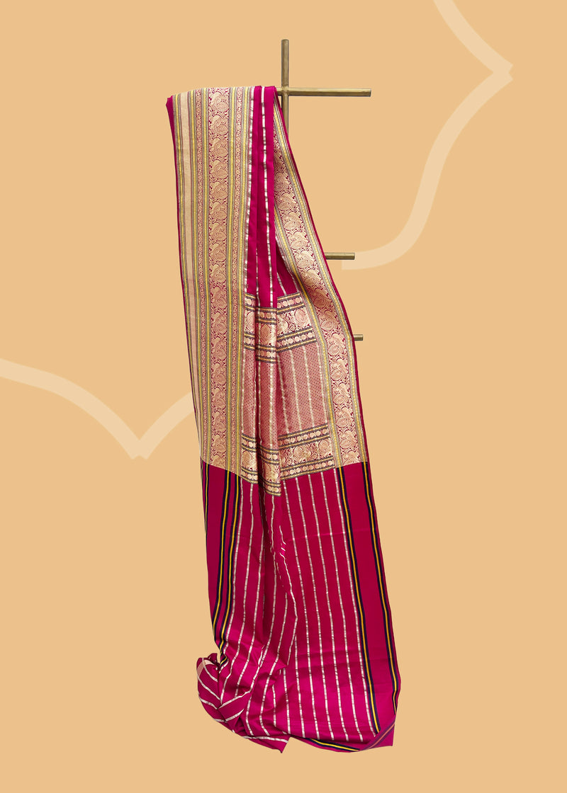 A striking pink satin saree with woven horizontal stripes and a stunning Kanjeevaram inspired border with zari brocade detailing and peacocks Shop the best collection of authentic, handwoven, pure benarasi sarees with Roliana New Delhi