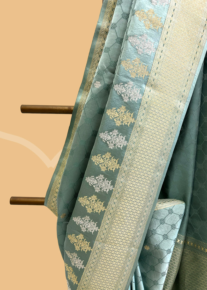 A beautiful powder blue satin tanchoi saree with silver and gold detalling of bootis and border. A pure Banarasi wedding Sari Shop the best collection of authentic, handwoven, pure benarasi sarees with Roliana New Delhi