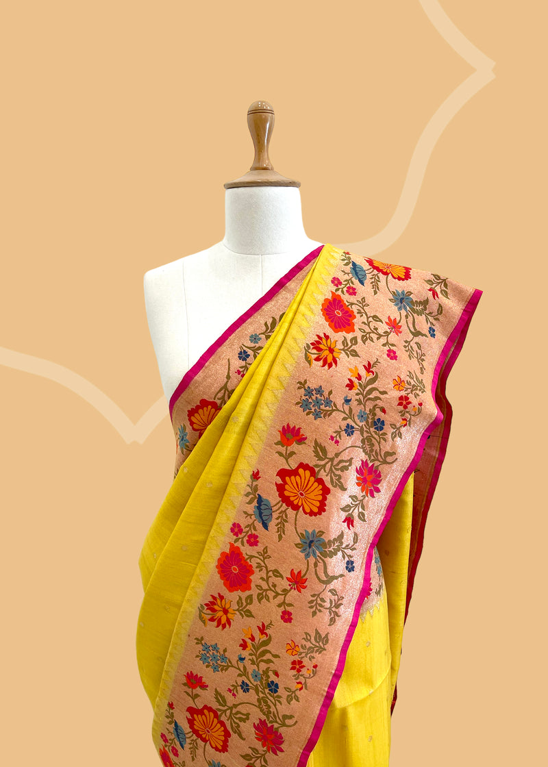 A delicate sunflower yellow saree with a striking meenakari floral border and delicate zari bootis all over. A pure Banarasi Sari Shop the best collection of authentic, handwoven, pure benarasi sarees with Roliana New Delhi