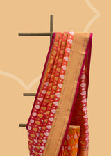 a traditional peach pink shot saree in silk with Sona roopa zari bootis and a chevron zari border and pallu. A pure Banarasi wedding Sari Shop the best collection of authentic, handwoven, pure benarasi sarees with Roliana New Delhi