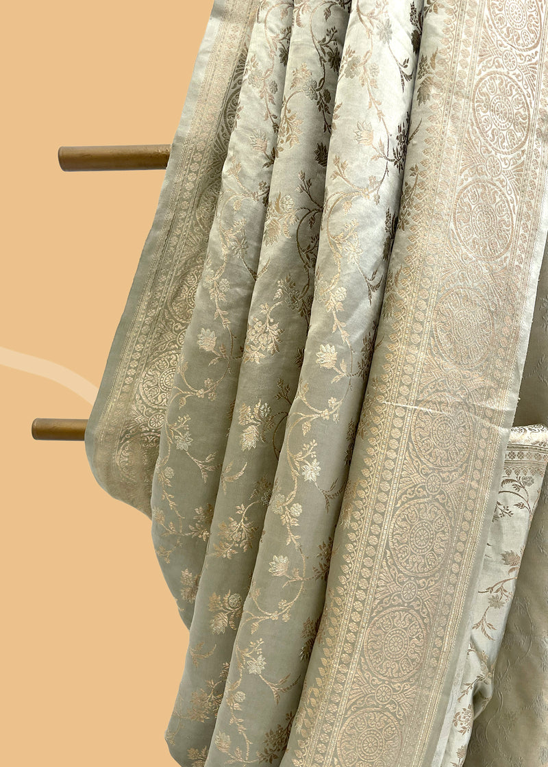  A gajji silk saree in egg shell gray with a delicate gold leaf jaal all over in a dainty weave.