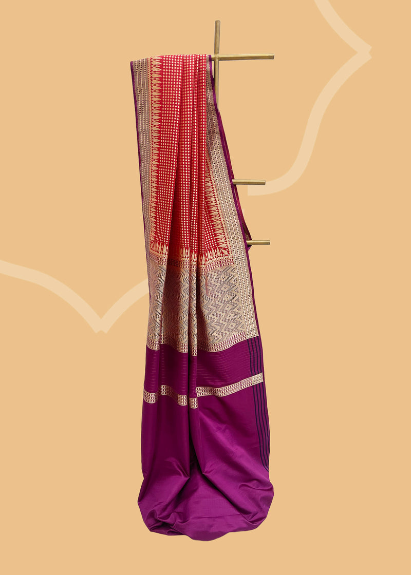 A flamboyant red woven satin silk saree with a beautiful contrast purple border and a chèvron pallu. Shop the best collection of authentic, handwoven, pure benarasi sarees with Roliana New Delhi