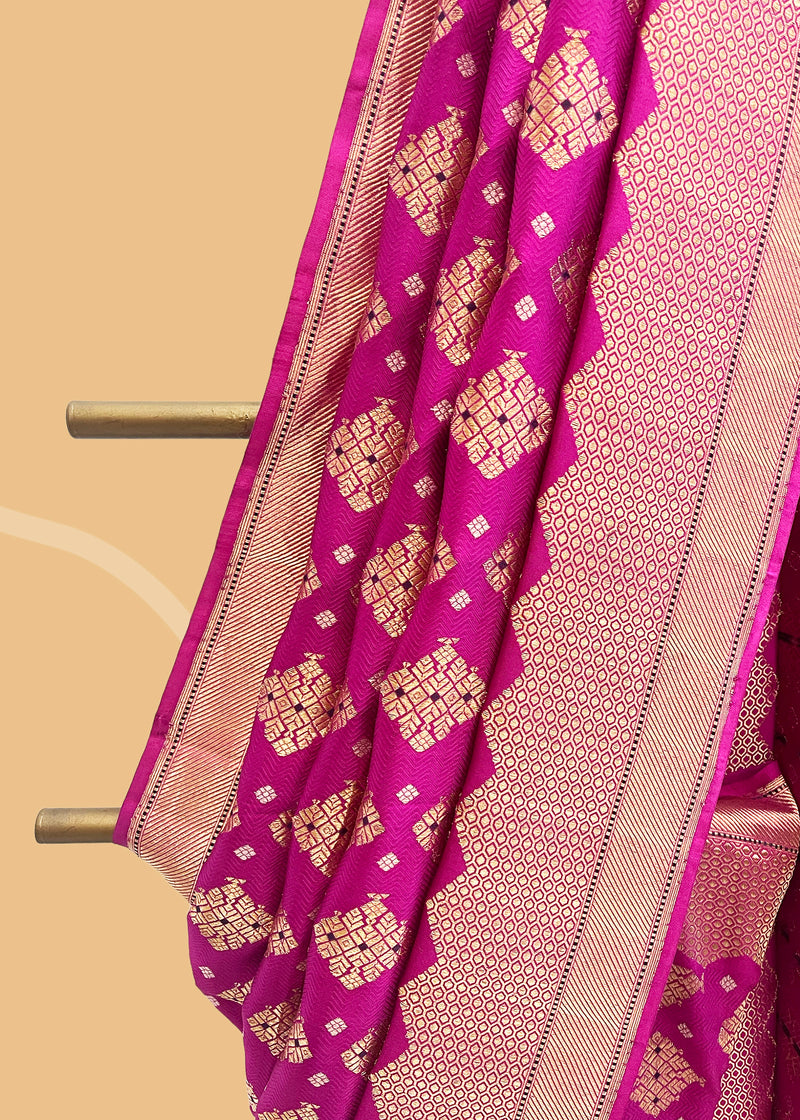 Ektaara tanchoi woven saree in rich pink with geometric bootis and a beautiful zari woven border and pallu. Shop the best collection of authentic, handwoven, pure benarasi sarees with Roliana New Delhi