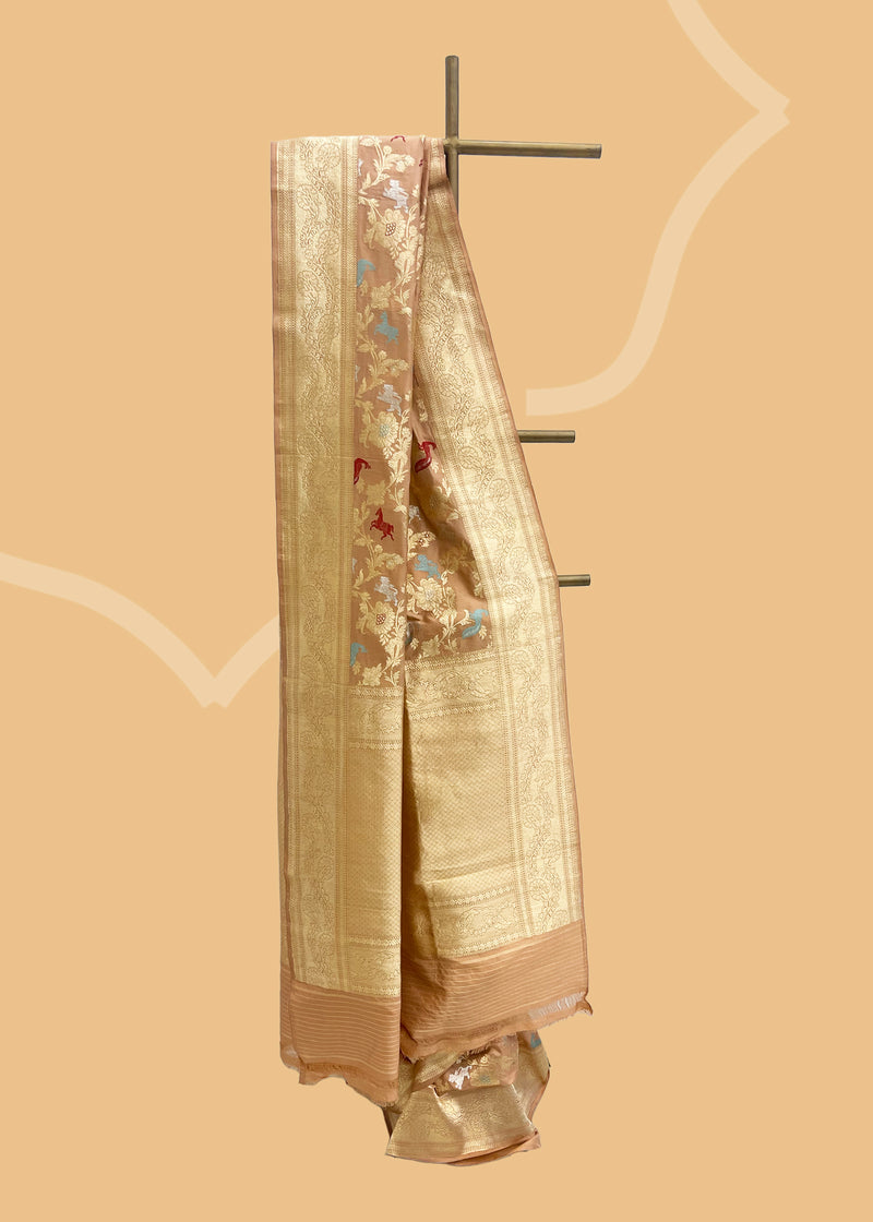 Peach gajji silk saree with zari kangoora jaal and meenakari shikargah weave finished with a zari upada border and pallu. Shop the best collection of authentic, handwoven, pure benarasi sarees with Roliana New Delhi