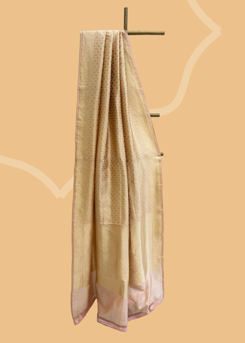 A soft peach brocade saree with meenakari details and a thos zari border. Shop the best collection of authentic, handwoven, pure benarasi sarees with Roliana New Delhi