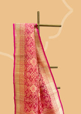 A peach coloured organza saree with Patola design weave in self matching and a zari border and pallu. Shop the best collection of authentic, handwoven, pure benarasi sarees with Roliana New Delhi