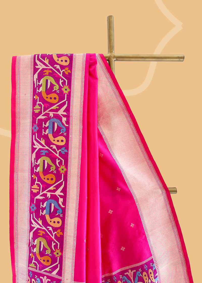 A silk Rani pink saree with bldelicate dot clusters all over and a beautiful paithani inspired woven border and pallu Shop the best collection of authentic, handwoven, pure benarasi sarees with Roliana New Delhi