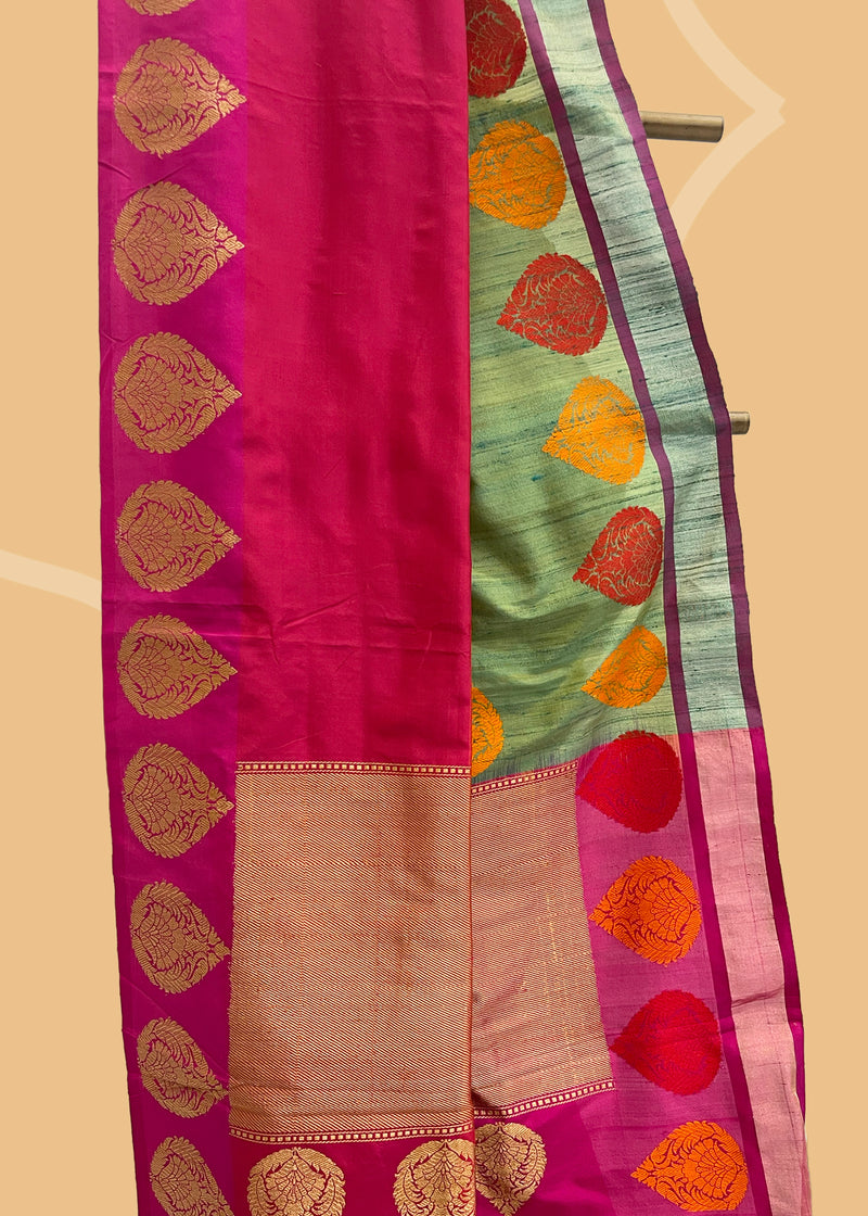 Mehndi green tussar silk saree with a rangkat border of burnt orange and red and zari kadhwa bootis all over the border and pallu. Shop the best collection of authentic, handwoven, pure benarasi sarees with Roliana New Delhi