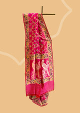 A beautiful Rani pink popat saree with ektaara kangoora jaal and an ornate Bel weave in meenakari border and pallu pure Banarasi sari. Shop the best collection of authentic, handwoven, pure benarasi sarees with Roliana New Delhi