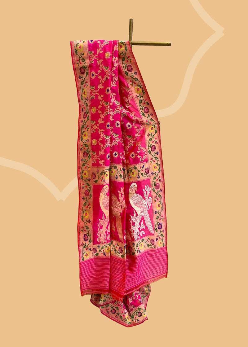 A beautiful Rani pink popat saree with ektaara kangoora jaal and an ornate Bel weave in meenakari border and pallu pure Banarasi sari. Shop the best collection of authentic, handwoven, pure benarasi sarees with Roliana New Delhi