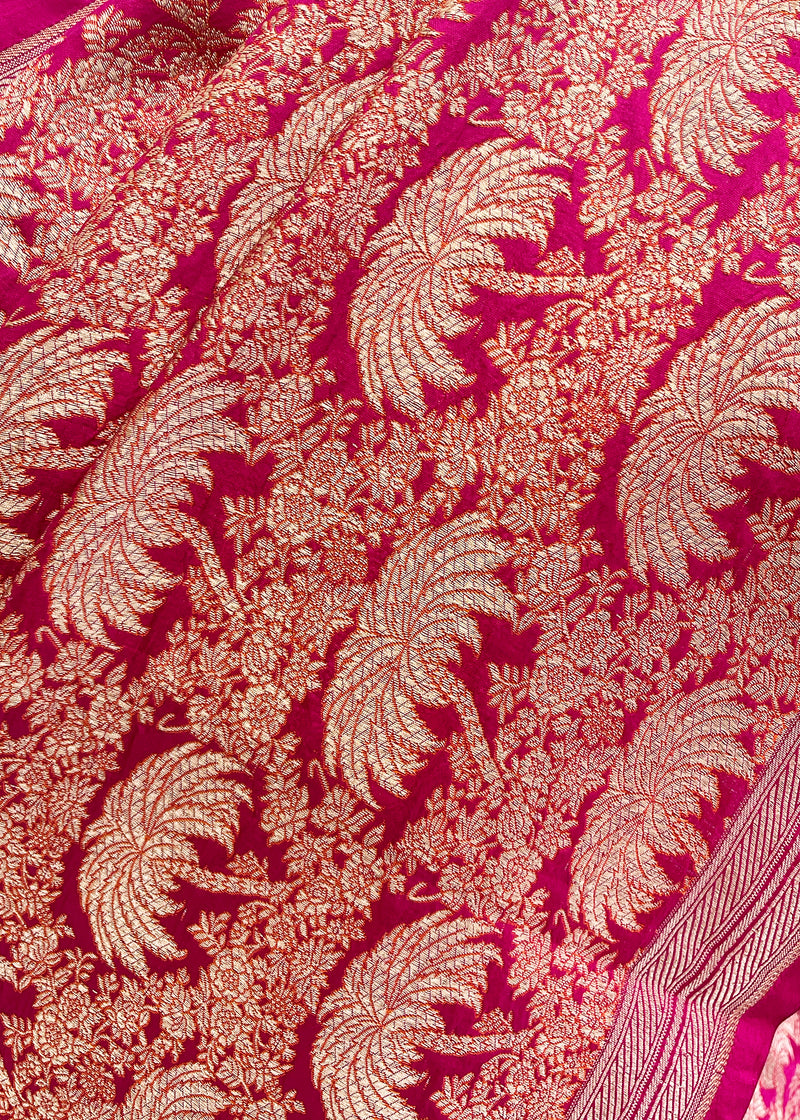 A Rani pink silk brocade saree with Khajur motifs all over and a thick foliage inlay jaal and a thin elegant border. Shop the best collection of authentic, handwoven, pure benarasi sarees with Roliana New Delhi