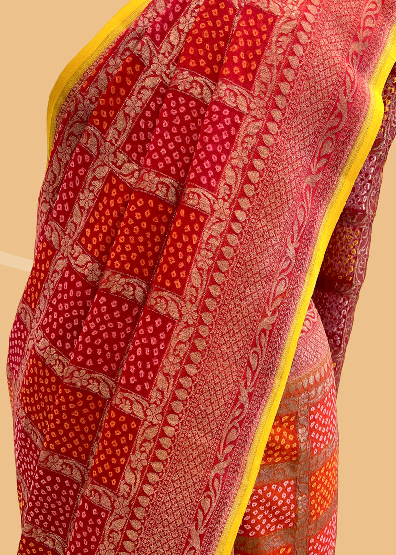 A Red shaded bandhani pure georgette saree in Benares weave suitable for all festive occasions. A pure Banarasi wedding Sari Shop the best collection of authentic, handwoven, pure benarasi sarees with Roliana New Delhi