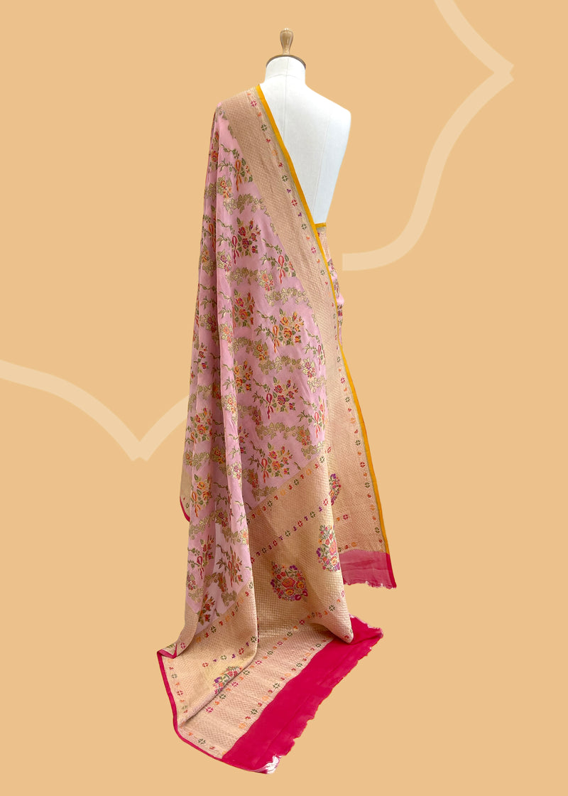 A Georgette woven saree in French flower bouquets and ribbon design all over and a delicate floral border. A pure Banarasi wedding Sari Shop the best collection of authentic, handwoven, pure benarasi sarees with Roliana New Delhi