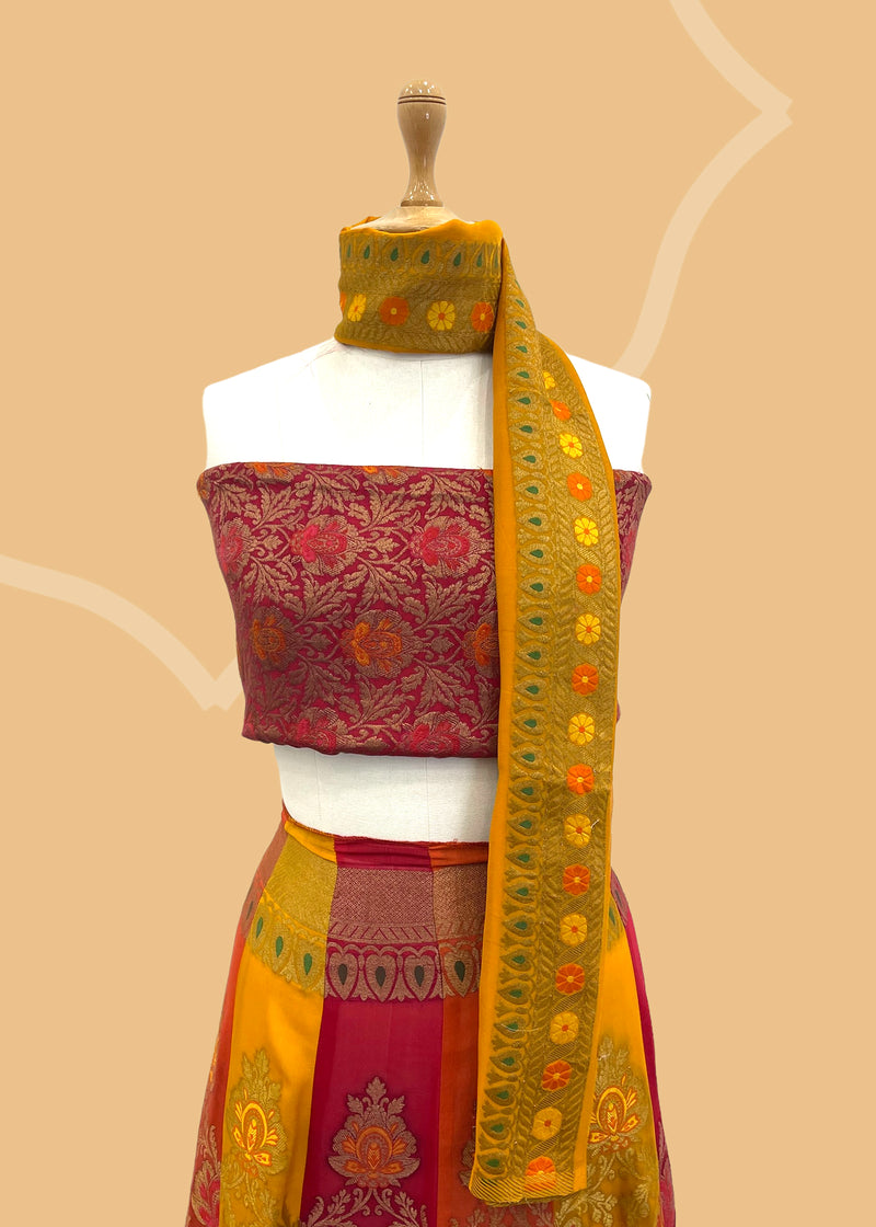 Benarasi georgette yellow red lehenga with hand painted flowers by Roliana Weaves. Shop the best of Pure Benarasi sarees and lehengas at Roliana New Delhi. 