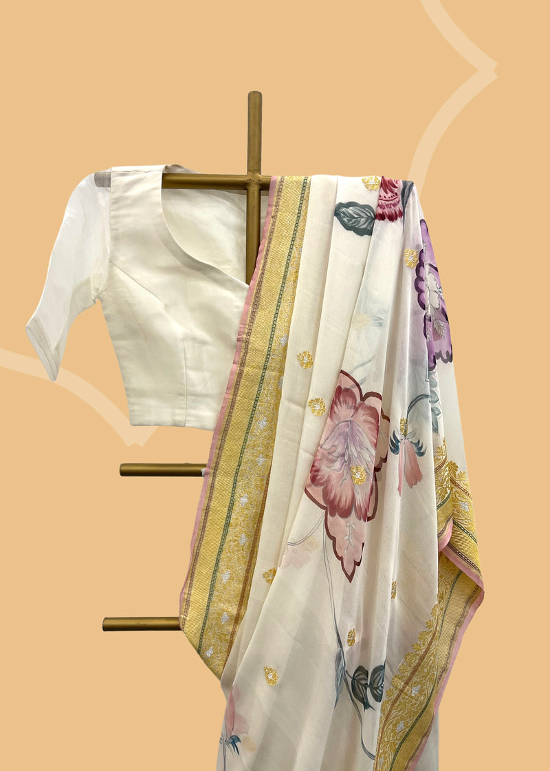 Pastel pure georgette Benarasi saree with handpainted flowers by Roliana Weaves Shop the best collection of authentic, handwoven, pure benarasi sarees with Roliana New Delhi