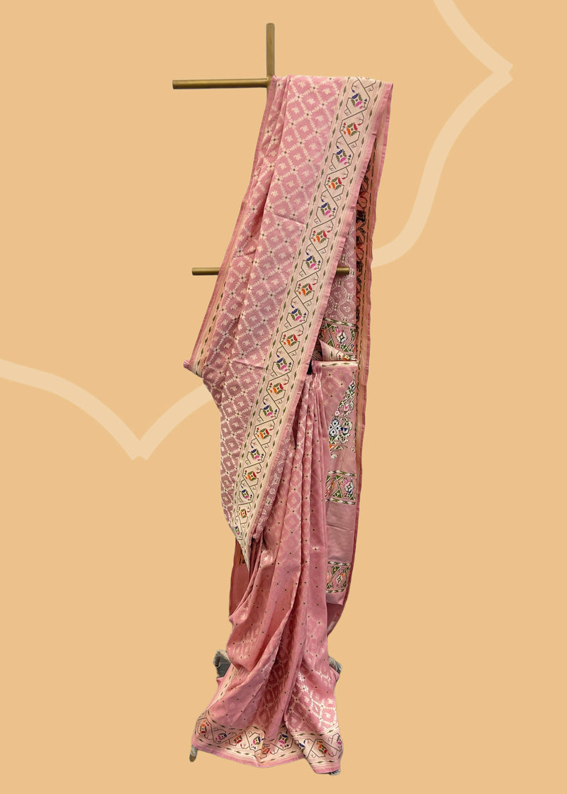 A blush pink silk tissue saree with barfi jaal and a woven meenakari paithani border and pallu