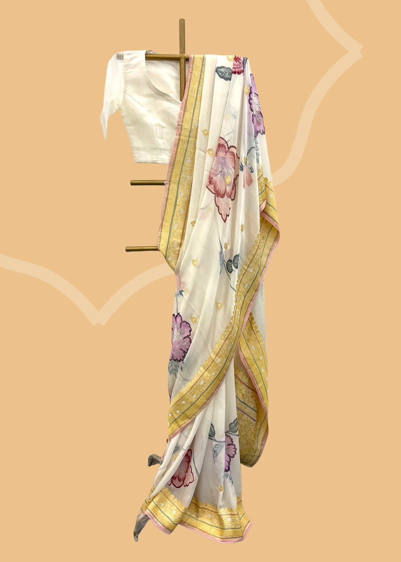 Pastel pure georgette Benarasi saree with handpainted flowers by Roliana Weaves Shop the best collection of authentic, handwoven, pure benarasi sarees with Roliana New Delhi