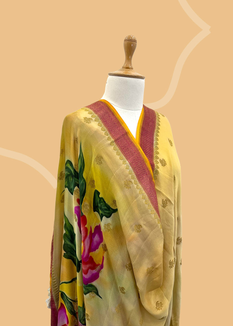 Pure silk benarasi dupatta in yellow with handpainted flowers by Roliana Weaves. Shop the best of Banarasi sarees, dupattas and lehengas at Roliana New Delhi
